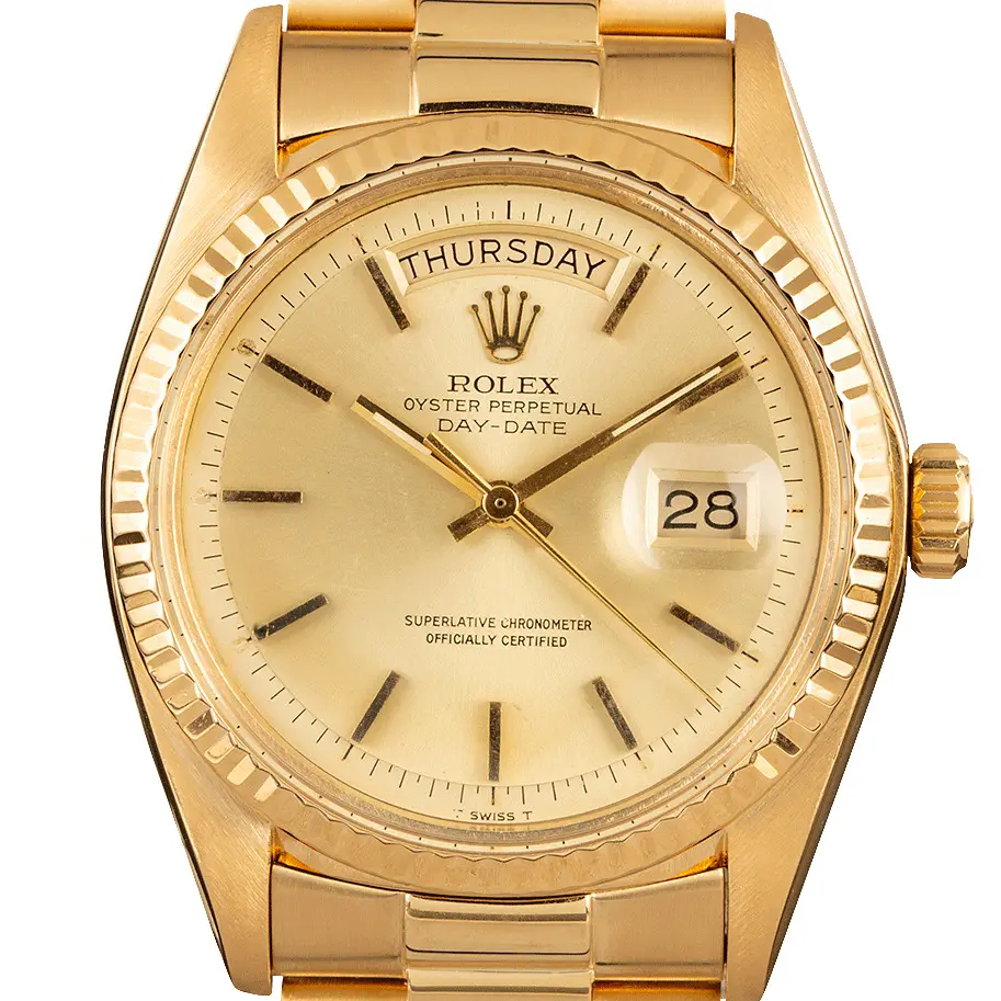 Rolex Day-Date 1803 with a champagne dial and fluted bezel in yellow gold on a President bracelet, a pre-owned example, studio close-up of the case