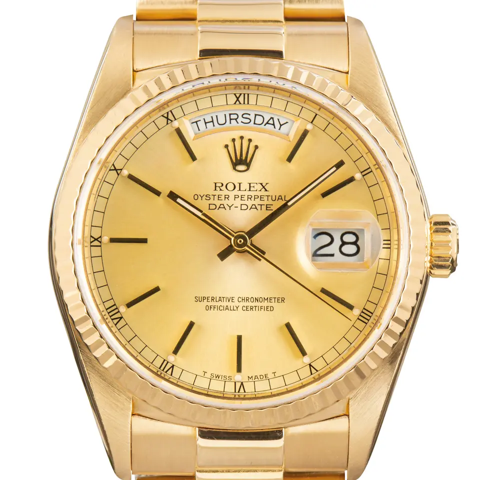 Rolex Day-Date 36 18038 with a champagne dial and fluted bezel in yellow gold on a President bracelet, a pre-owned example, studio close-up of the case
