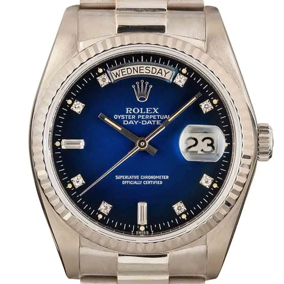 Rolex Day-Date 36 18039 with a blue vignette dial with diamond markers and fluted bezel in white gold on a President bracelet, a pre-owned example, studio close-up of the case
