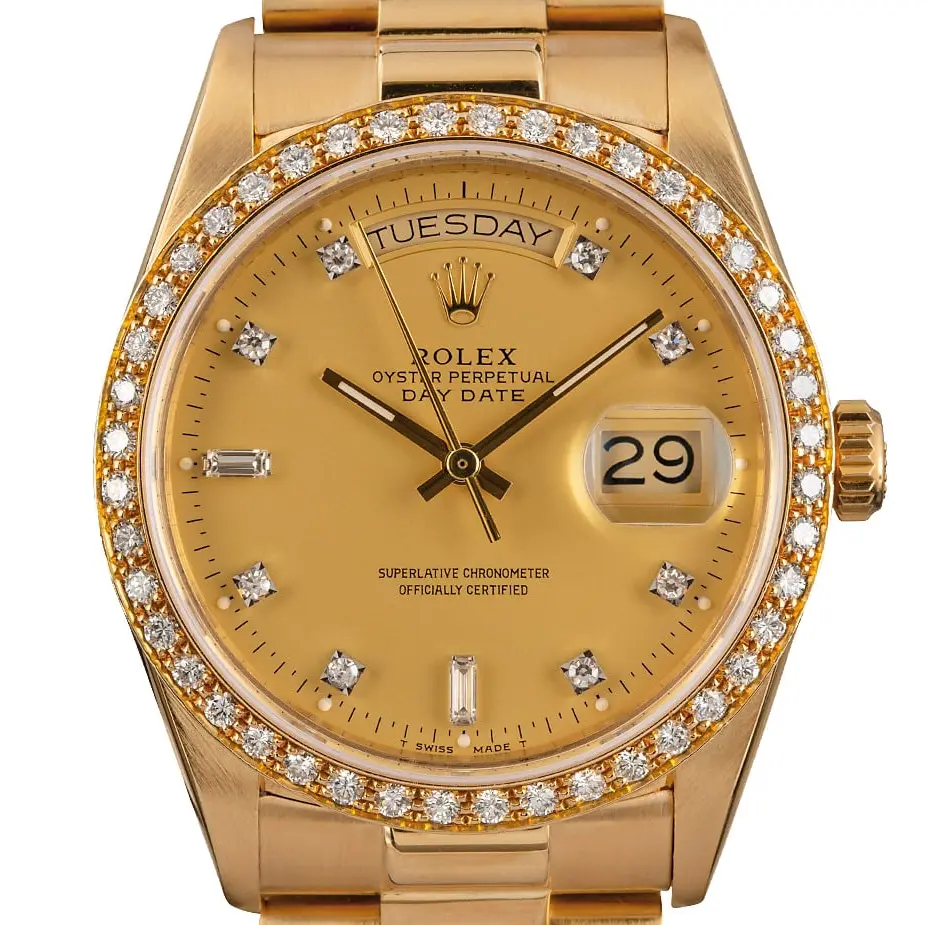 Rolex Day-Date 36 18048 with a champagne dial with diamond hour markers, diamond-set bezel and yellow gold President bracelet, a pre-owned example, studio close-up of the case