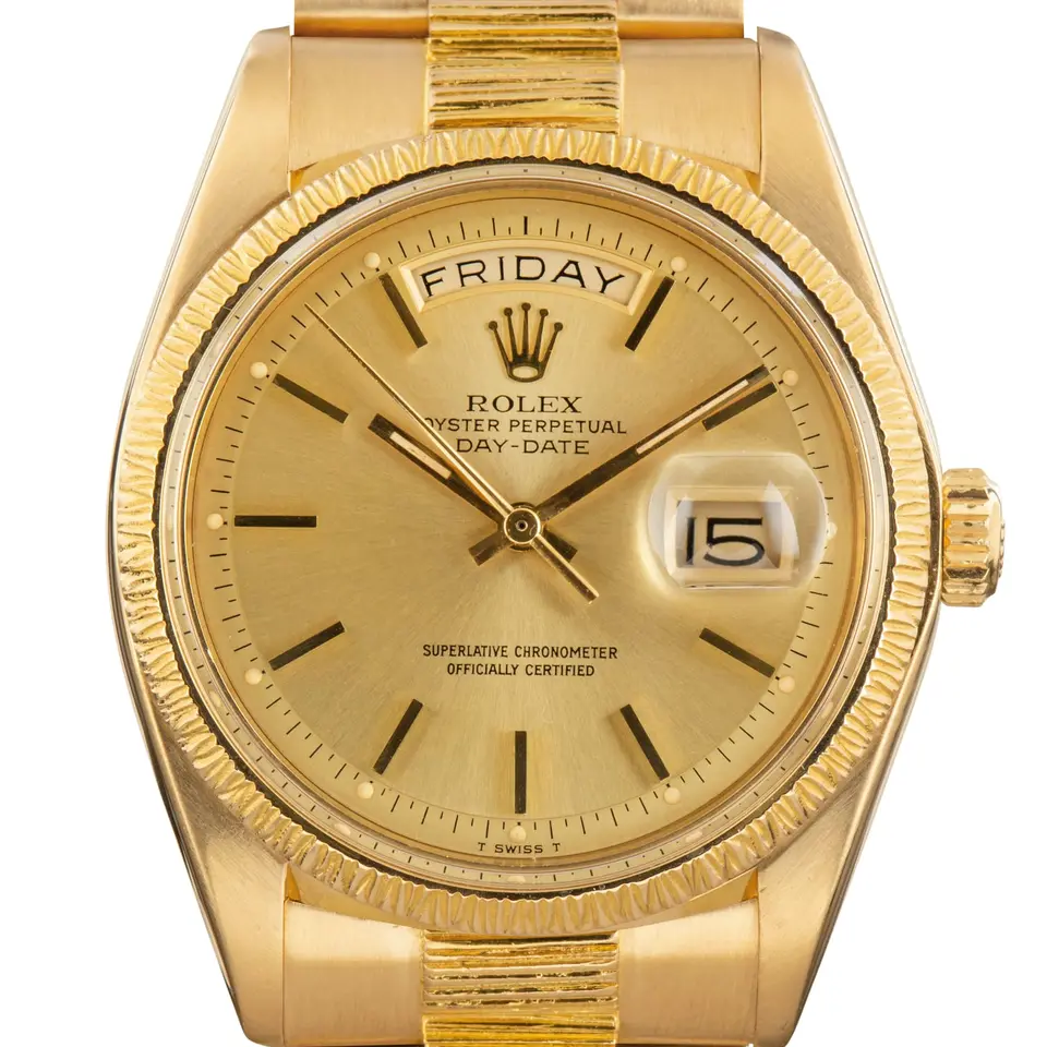 Rolex Day-Date 1807 with a champagne dial, bark-finish yellow gold bezel and bark-finish President bracelet, a pre-owned example, studio close-up of the case