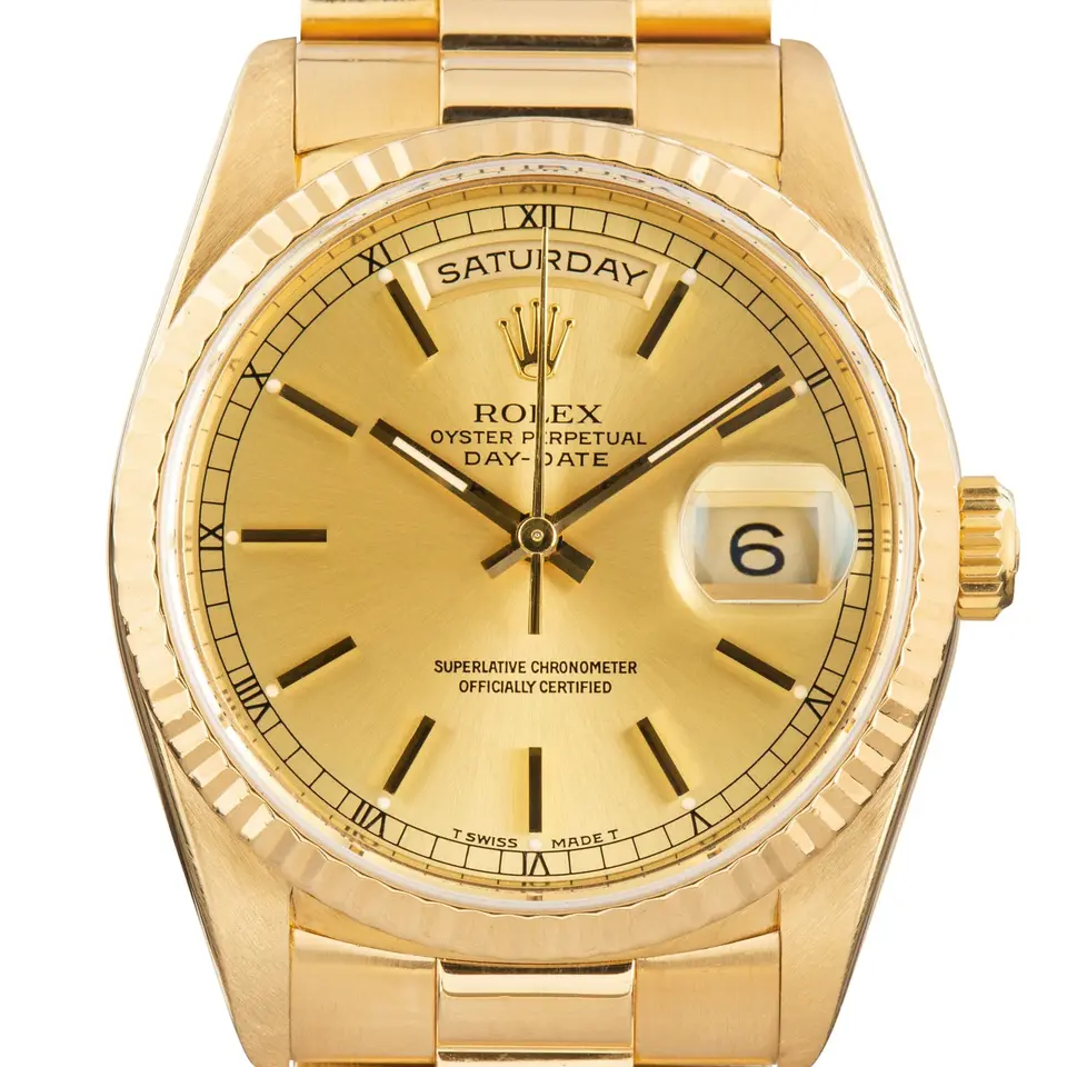 Rolex Day-Date 36 18238 with a champagne dial and fluted bezel in yellow gold on a President bracelet, a pre-owned example, studio close-up of the case