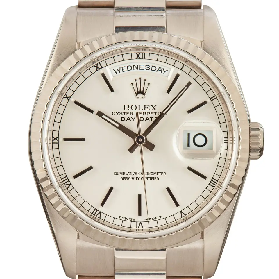 Rolex Day-Date 36 18239 with a silver dial with baton markers and a fluted white gold bezel on a white gold President bracelet, a pre-owned example, studio close-up of the case
