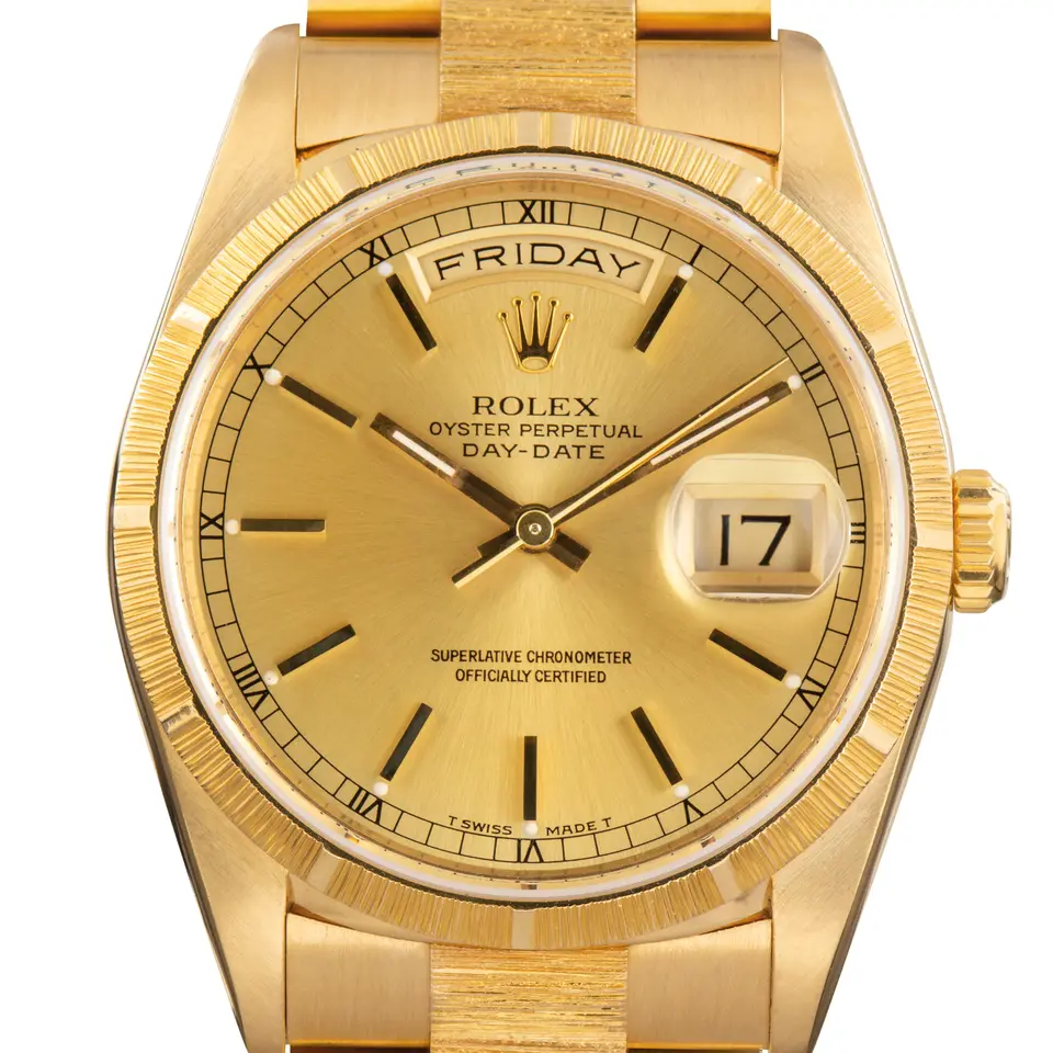 Rolex Day-Date 36 18248 with a champagne dial, bark-finish yellow gold bezel and bark-finish President bracelet, a pre-owned example, studio close-up of the case