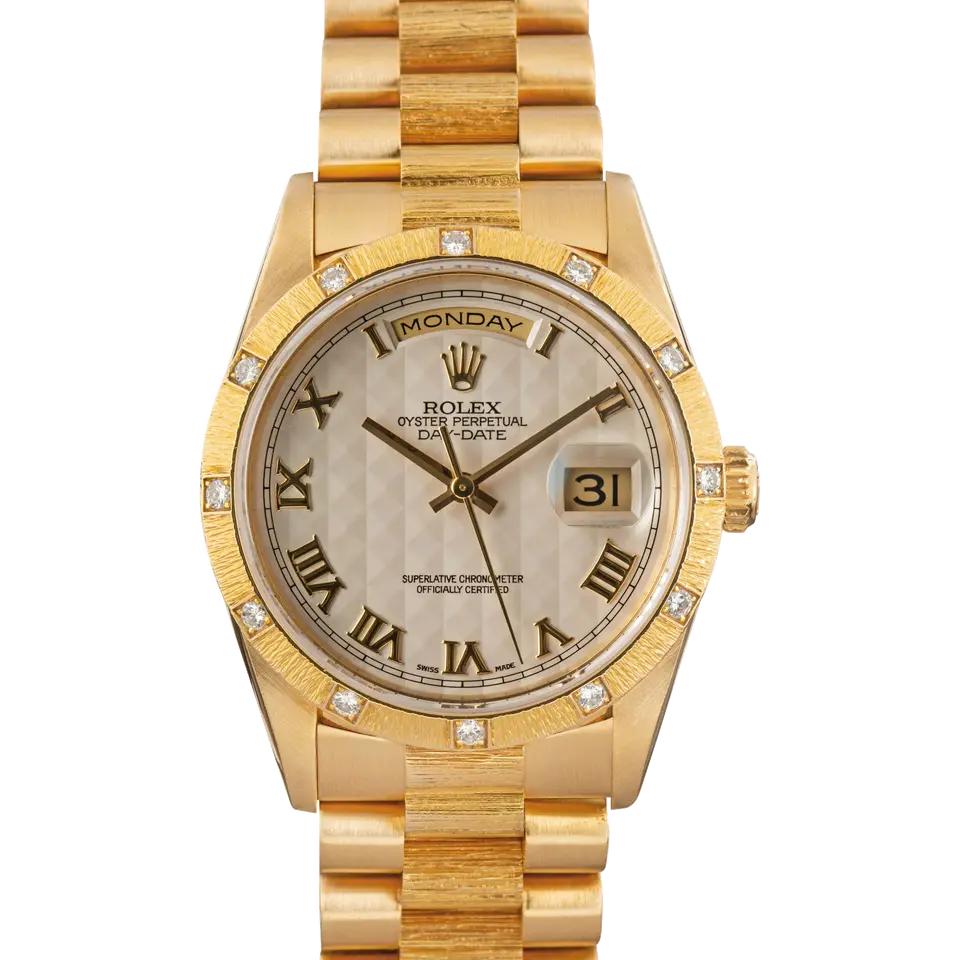 Rolex Day-Date 36 18308 with a silver pyramid Roman-numeral dial, bark-finish yellow gold bezel set with diamonds and yellow gold President bracelet, a pre-owned example, front view of the whole watch