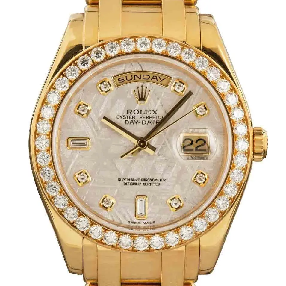 Rolex Day-Date 18948 with a meteorite dial with diamond hour markers, diamond-set bezel and yellow gold Masterpiece bracelet, a pre-owned example, studio close-up of the case