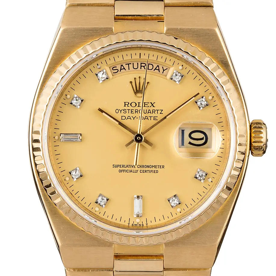 Rolex Day-Date 19018 with a champagne dial with diamond markers in yellow gold on an integrated Oysterquartz bracelet, a pre-owned example, studio close-up of the case