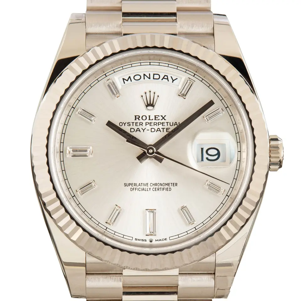 Rolex Day-Date 40 228239 with a silver dial with baguette diamond markers and a fluted white gold bezel, a pre-owned example, studio close-up of the case