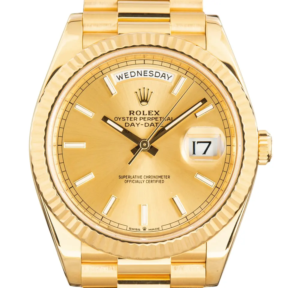 Rolex Day-Date 40 228238 in yellow gold with a champagne dial, day window, fluted bezel and President bracelet, a pre-owned example, studio close-up of the case