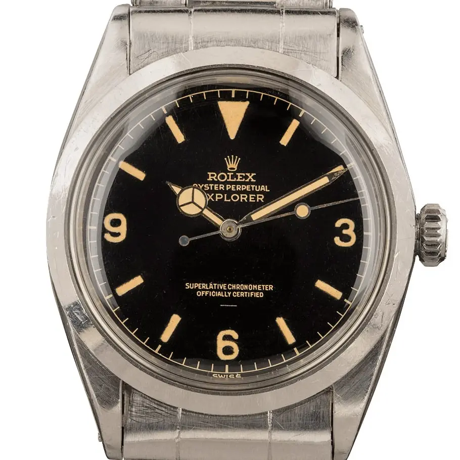 Rolex Explorer 1016 with a glossy black gilt dial with 3, 6 and 9 numerals on a steel Oyster bracelet, a pre-owned example, studio close-up of the case