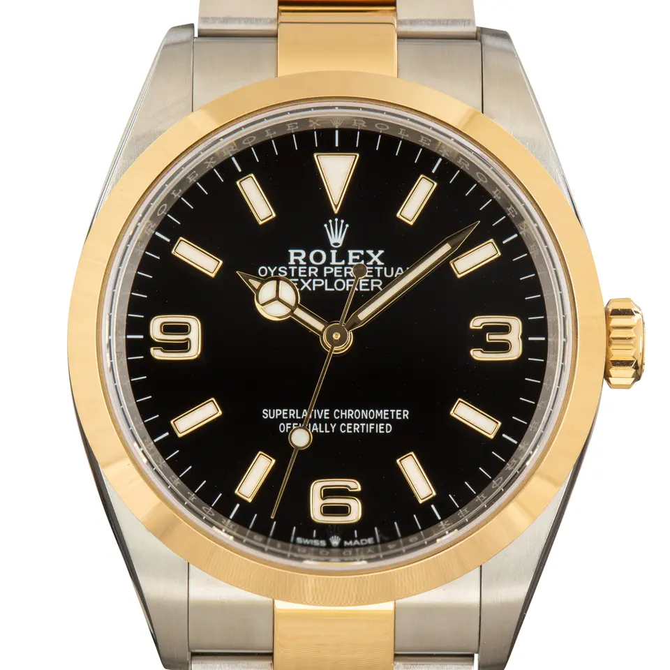 Rolex Explorer 124273 with a black dial with 3, 6 and 9 numerals and a smooth yellow gold bezel, a pre-owned example, studio close-up of the case