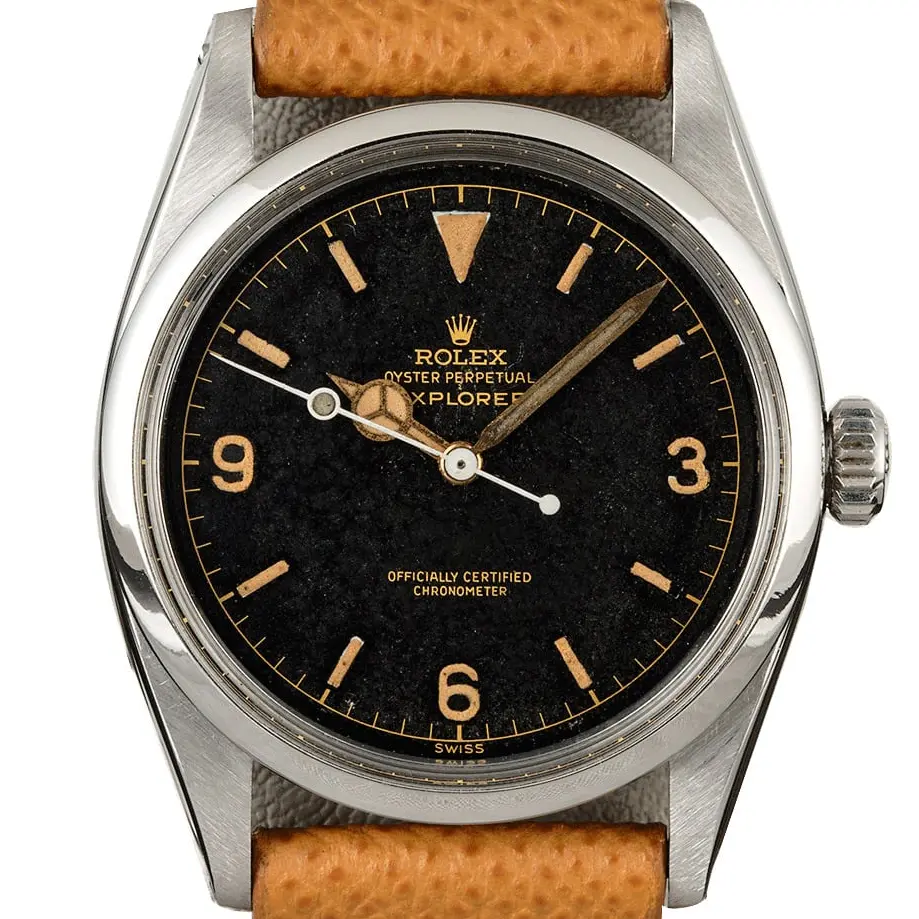 Rolex Explorer 6610 with a black gilt dial with 3, 6 and 9 numerals and a smooth steel bezel on a tan leather strap, a pre-owned example, studio close-up of the case