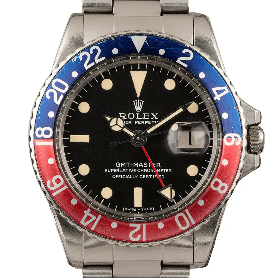 Rolex GMT-Master 1675 with a black dial and blue and red aluminium bezel insert on a steel Oyster bracelet, a pre-owned example, studio close-up of the case