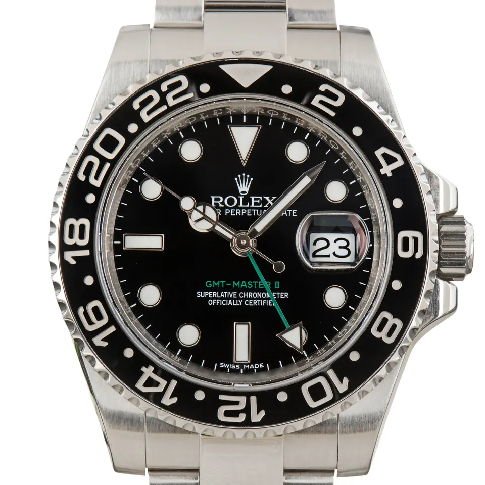 Rolex GMT-Master II 116710LN with a black dial, green GMT hand and black ceramic bezel on a steel Oyster bracelet, a pre-owned example, studio close-up of the case