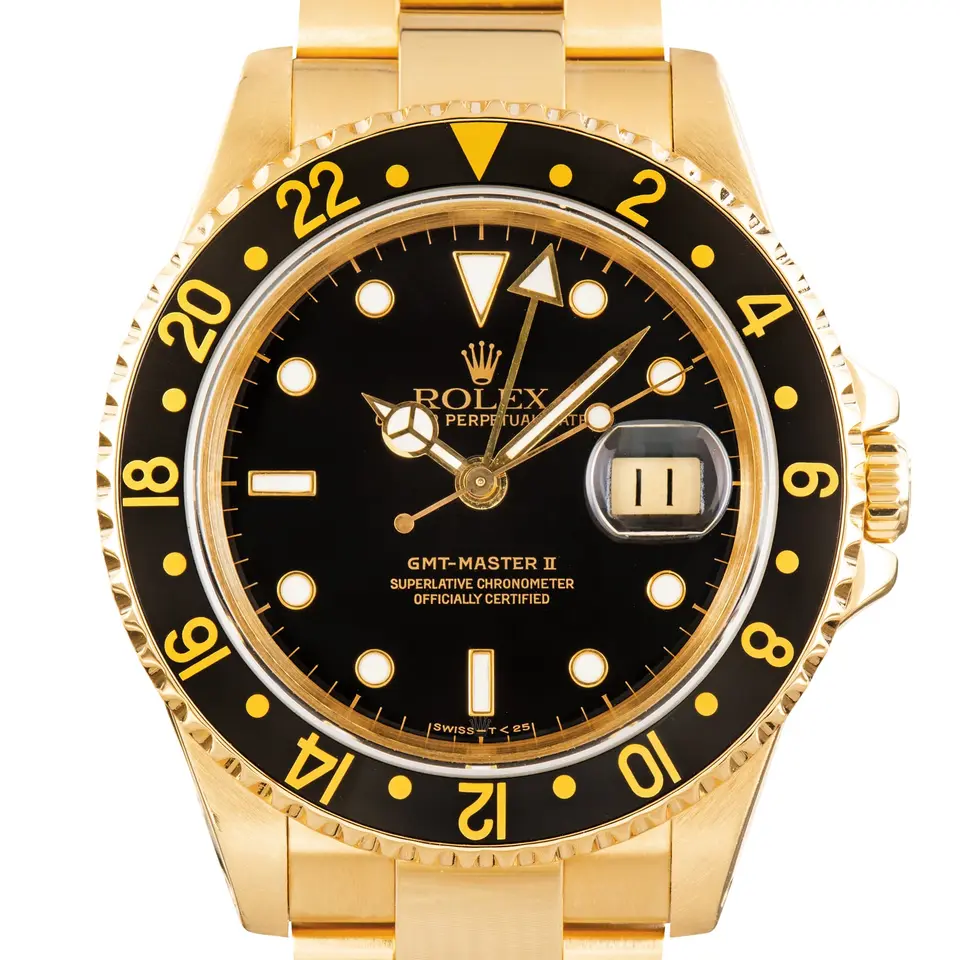 Rolex GMT-Master II 16718 with a black dial and black bezel in yellow gold on an Oyster bracelet, a pre-owned example, studio close-up of the case