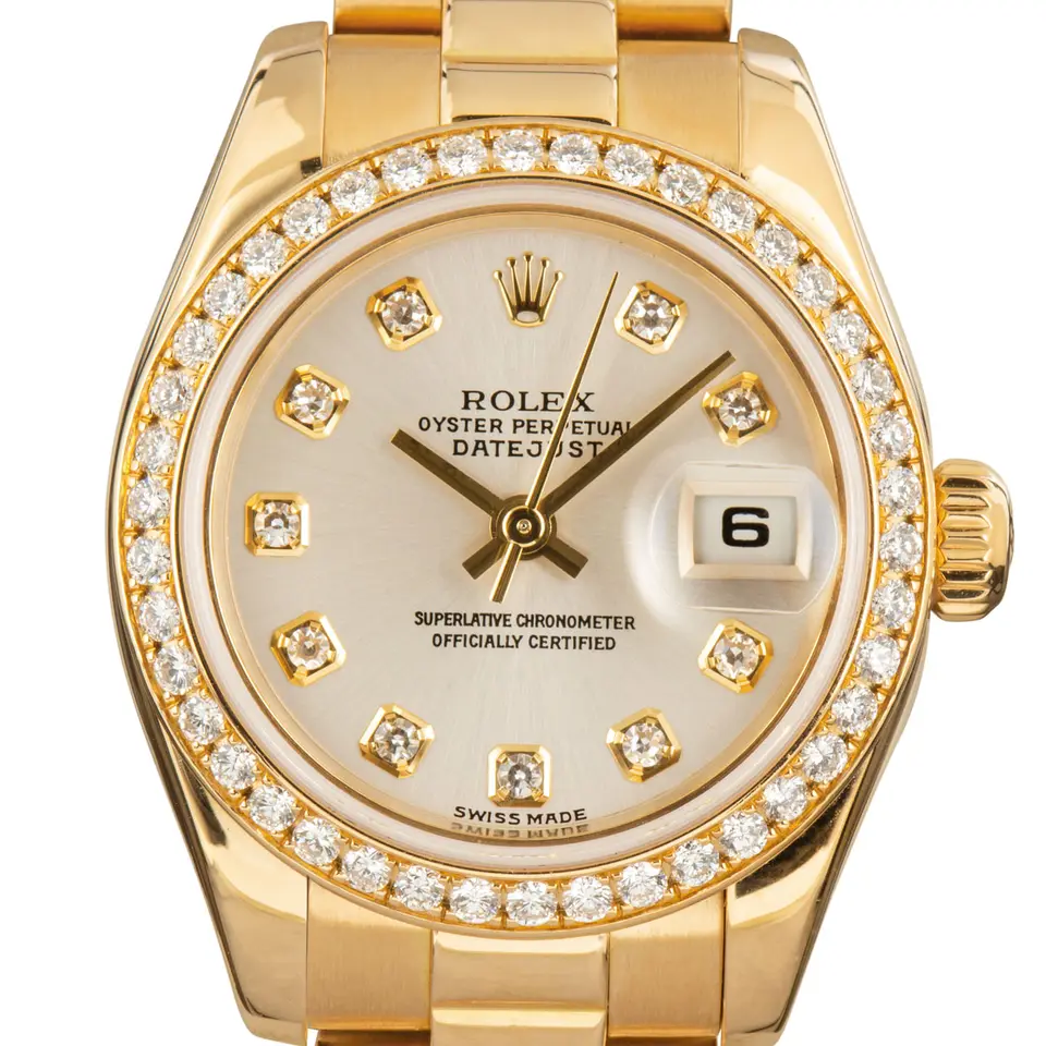 Rolex Lady-Datejust 179138 with a mother-of-pearl dial with diamond hour markers, diamond-set bezel and yellow gold President bracelet, a pre-owned example, studio close-up of the case