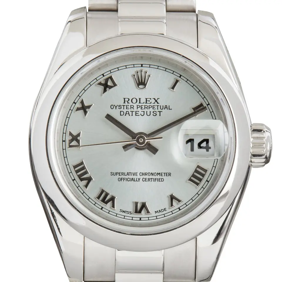 Rolex Lady-Datejust 179166 with an ice-blue Roman-numeral dial, smooth platinum bezel and platinum President bracelet, a pre-owned example, studio close-up of the case
