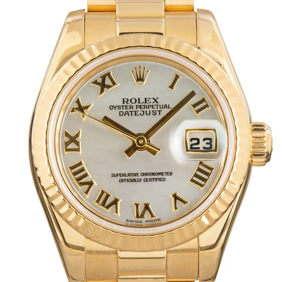 Rolex Lady-Datejust 26 179178 with a mother-of-pearl Roman-numeral dial, fluted yellow gold bezel and yellow gold President bracelet, a pre-owned example, studio close-up of the case