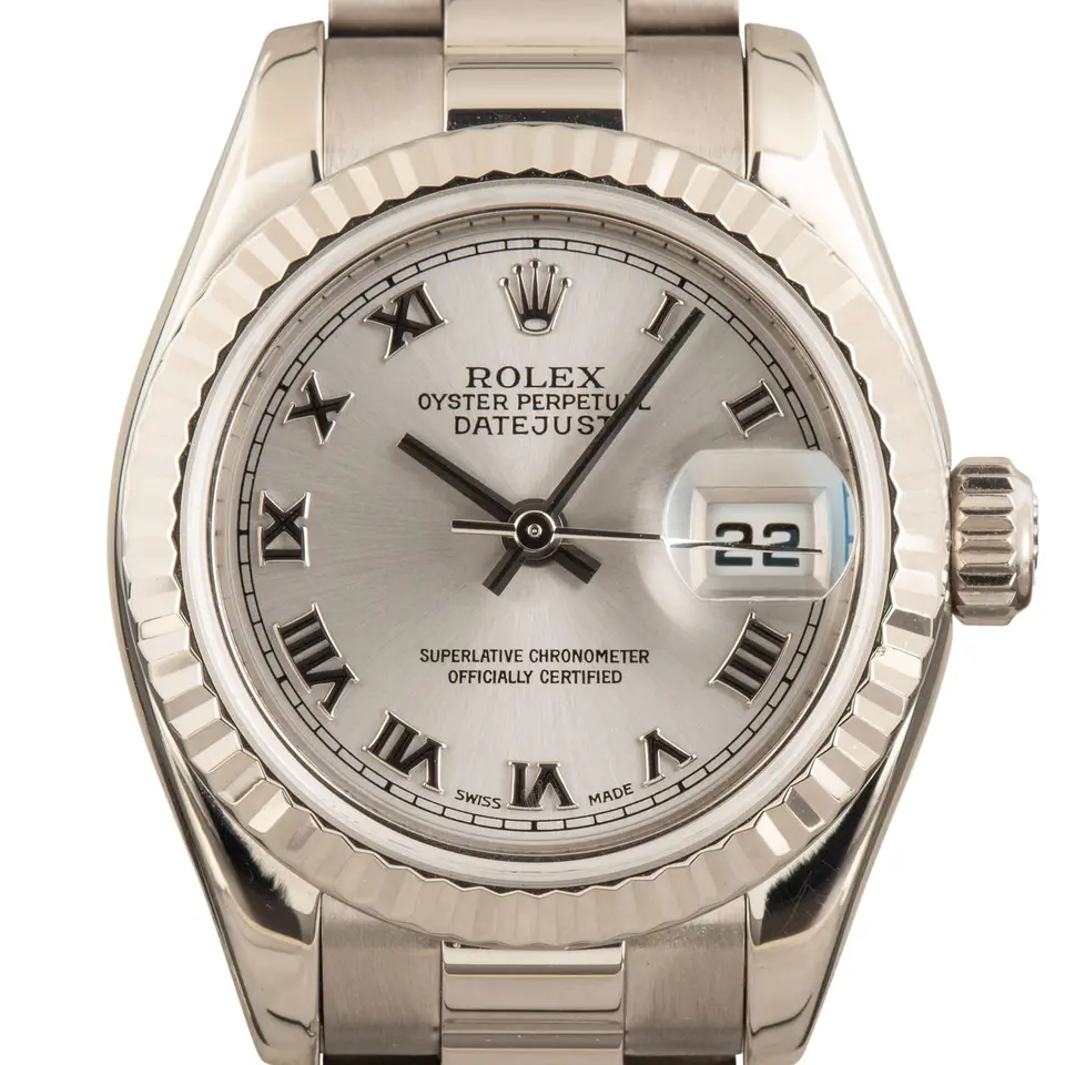 Rolex Lady-Datejust 26 179179 with a silver Roman-numeral dial, fluted white gold bezel and white gold President bracelet, a pre-owned example, studio close-up of the case