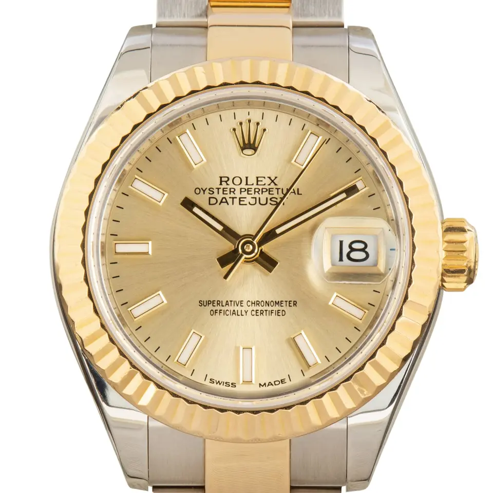 Rolex Lady-Datejust 279173 with a golden dial and a fluted yellow gold bezel, a pre-owned example, studio close-up of the case