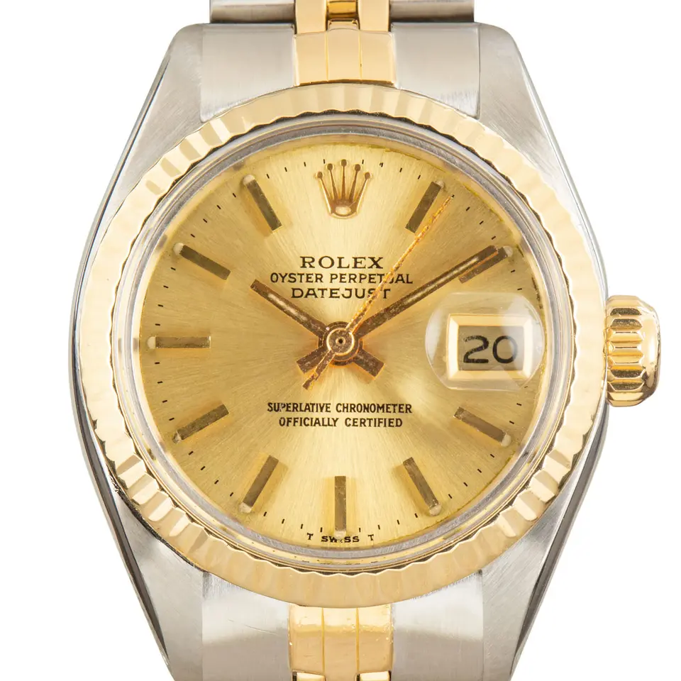 Rolex Lady-Datejust 6917 with a champagne dial and fluted yellow gold bezel in steel and yellow gold on a Jubilee bracelet, a pre-owned example, studio close-up of the case