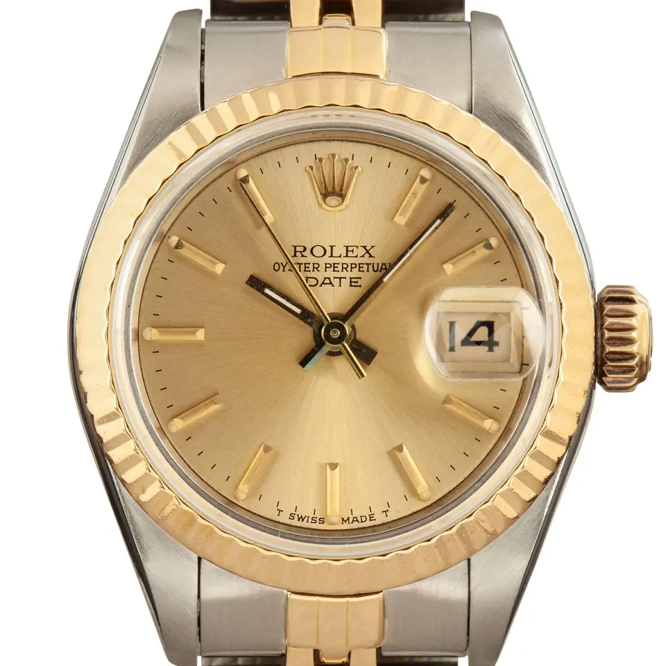 Rolex Lady-Datejust 69173 with a champagne dial and fluted yellow gold bezel in steel and yellow gold on a Jubilee bracelet, a pre-owned example, studio close-up of the case