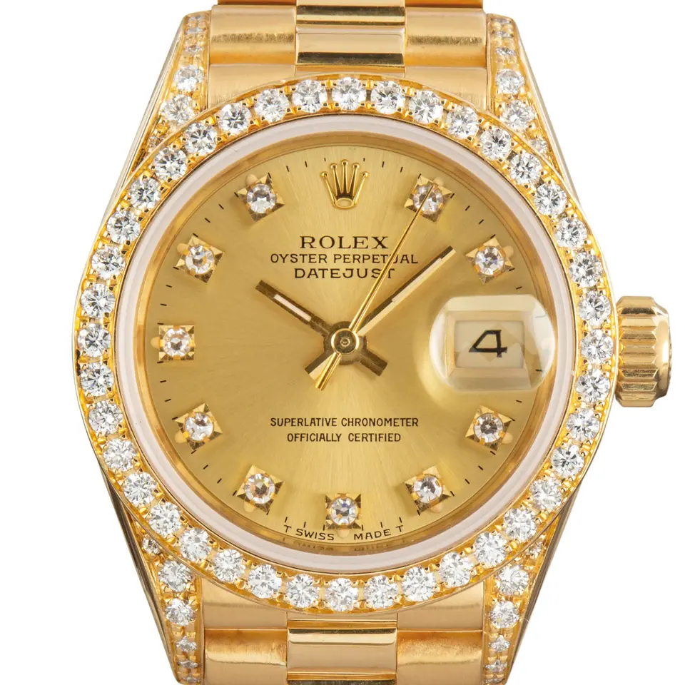 Rolex Lady-Datejust 69188 with a champagne dial with diamond hour markers, diamond-set bezel, diamond-set lugs and yellow gold President bracelet, a pre-owned example, studio close-up of the case