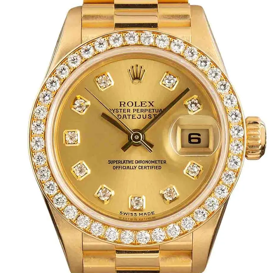 Rolex Lady-Datejust 79138 with a champagne dial with diamond hour markers, diamond-set bezel and yellow gold President bracelet, a pre-owned example, studio close-up of the case