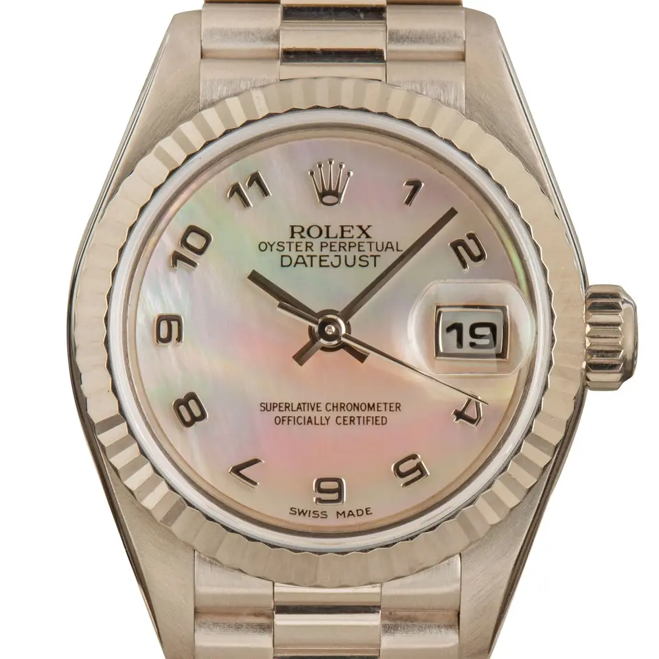 Rolex Lady-Datejust 79179 with a mother-of-pearl Arabic-numeral dial, fluted white gold bezel and white gold President bracelet, a pre-owned example, studio close-up of the case