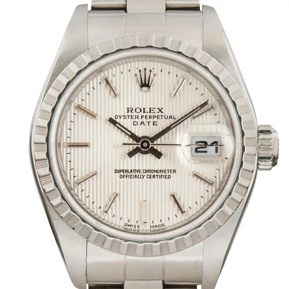 Rolex Lady-Datejust 79240 with a silver tapestry dial, engine-turned steel bezel and steel Oyster bracelet, a pre-owned example, studio close-up of the case