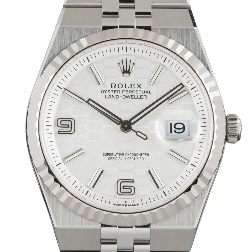 Rolex Land-Dweller 127234 in steel and white gold with an intense white honeycomb-motif dial, fluted white gold bezel and Flat Jubilee bracelet, a pre-owned example, studio close-up of the case