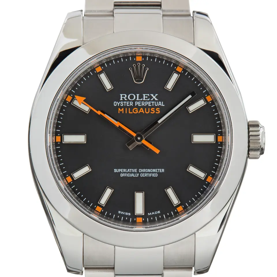 Rolex Milgauss 116400 with a black dial with orange accents and smooth steel bezel on an Oyster bracelet, a pre-owned example, studio close-up of the case