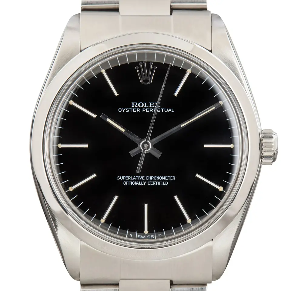 Rolex Oyster Perpetual 1002 with a black dial, smooth steel bezel and steel Oyster bracelet, a pre-owned example, studio close-up of the case