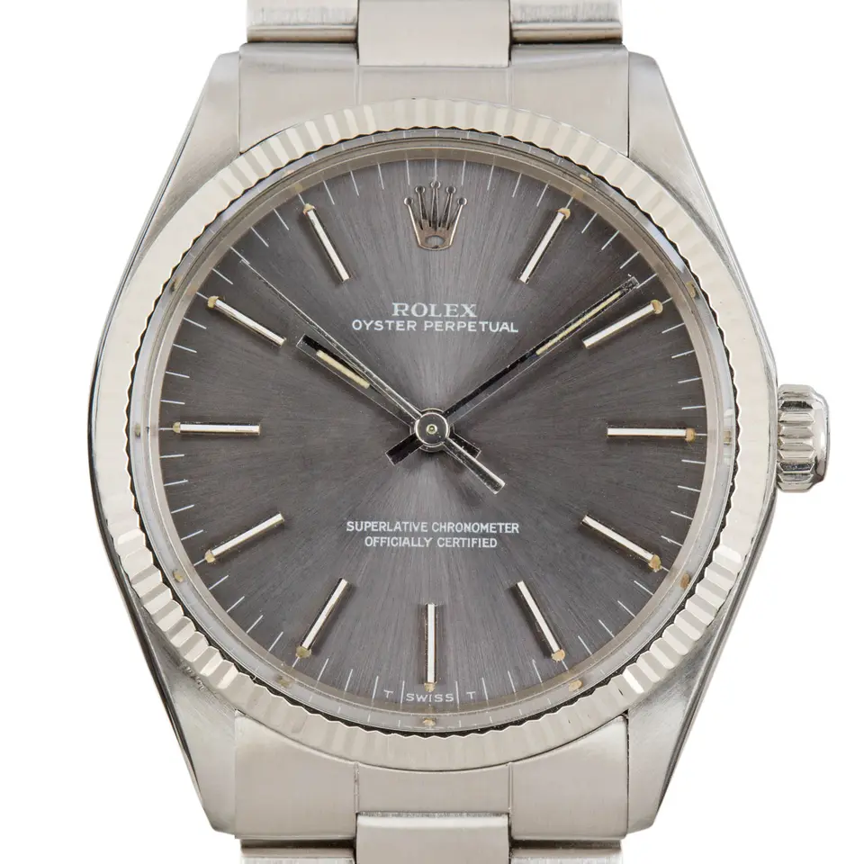 Rolex Oyster Perpetual 34 1005 with a slate dial with baton markers and a smooth steel bezel on a steel Oyster bracelet, a pre-owned example, studio close-up of the case