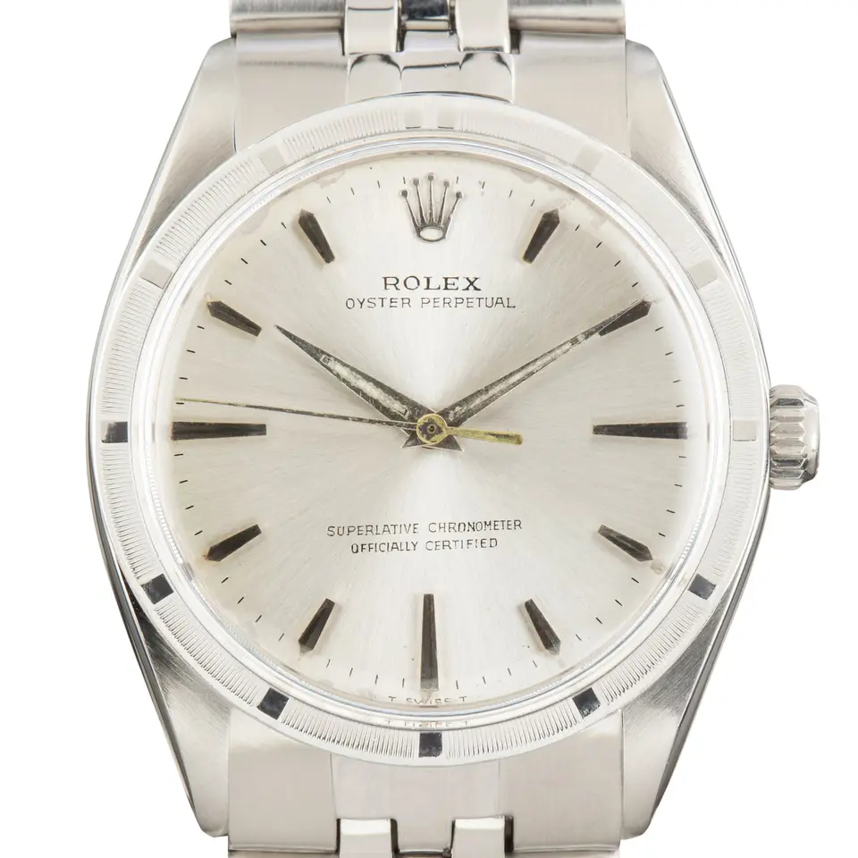 Rolex Oyster Perpetual 34 1007 with a silver dial, engine-turned steel bezel and steel Oyster bracelet, a pre-owned example, studio close-up of the case