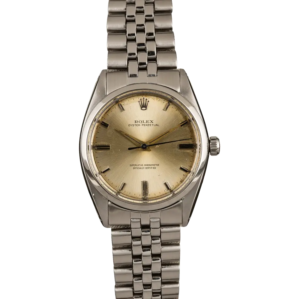 Rolex Oyster Perpetual 1018 with a champagne dial, smooth steel bezel and steel rivet bracelet, a pre-owned example, front view of the whole watch