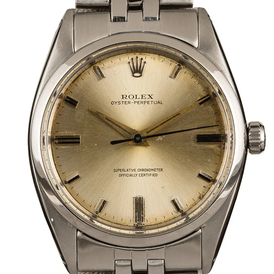 Rolex Oyster Perpetual 1018 with a champagne dial, smooth steel bezel and steel rivet bracelet, a pre-owned example, studio close-up of the case