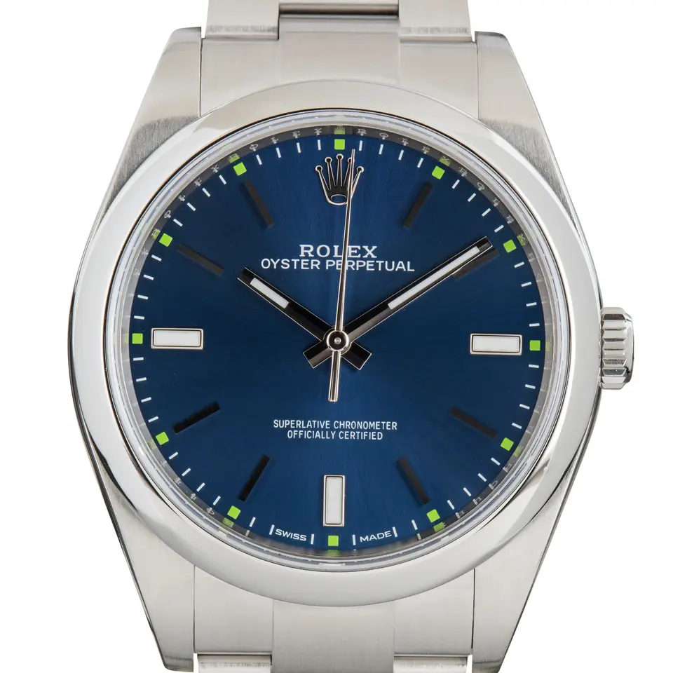 Rolex Oyster Perpetual 39 114300 with a blue dial and smooth steel bezel on an Oyster bracelet, a pre-owned example, studio close-up of the case