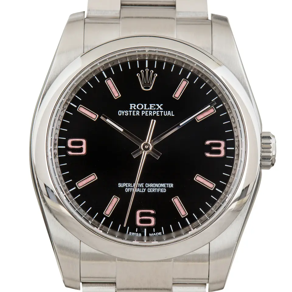 Rolex Oyster Perpetual 36 116000 with a black dial with 3, 6 and 9 numerals and smooth steel bezel on an Oyster bracelet, a pre-owned example, studio close-up of the case