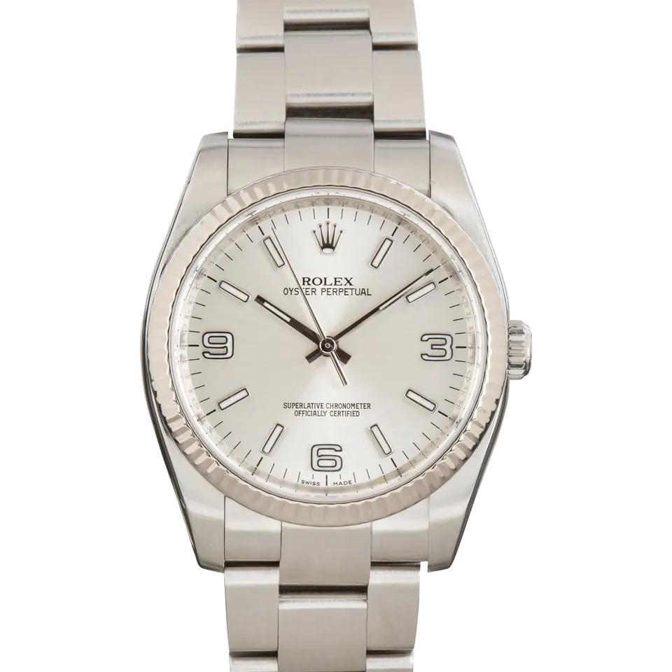 Rolex Oyster Perpetual 36 116034 with a silver Arabic-numeral dial, fluted white gold bezel and steel Oyster bracelet, a pre-owned example, front view of the whole watch