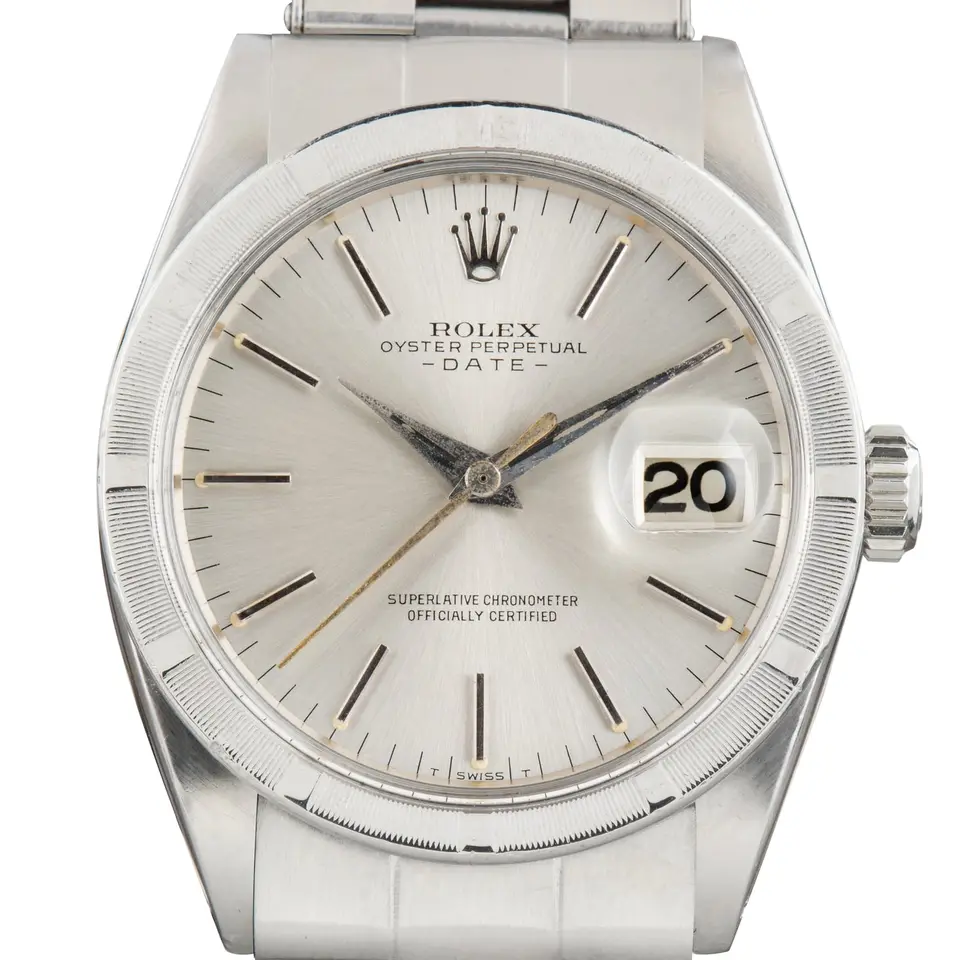 Rolex Oyster Perpetual Date 34 1501 with a silver dial with date window and engine-turned steel bezel on an Oyster bracelet, a pre-owned example, studio close-up of the case
