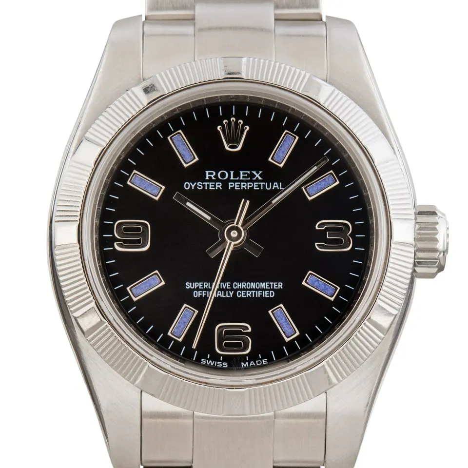 Rolex Oyster Perpetual 26 176210 with a black dial with 3, 6 and 9 numerals, engine-turned steel bezel and steel Oyster bracelet, a pre-owned example, studio close-up of the case