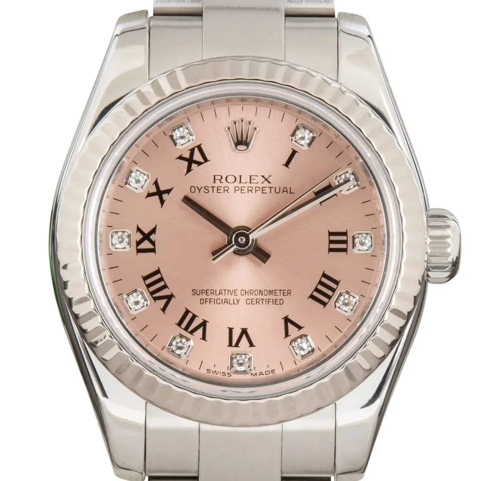 Rolex Oyster Perpetual 26 176234 with a pink Roman-numeral dial with diamond markers, fluted white gold bezel and steel Oyster bracelet, a pre-owned example, studio close-up of the case