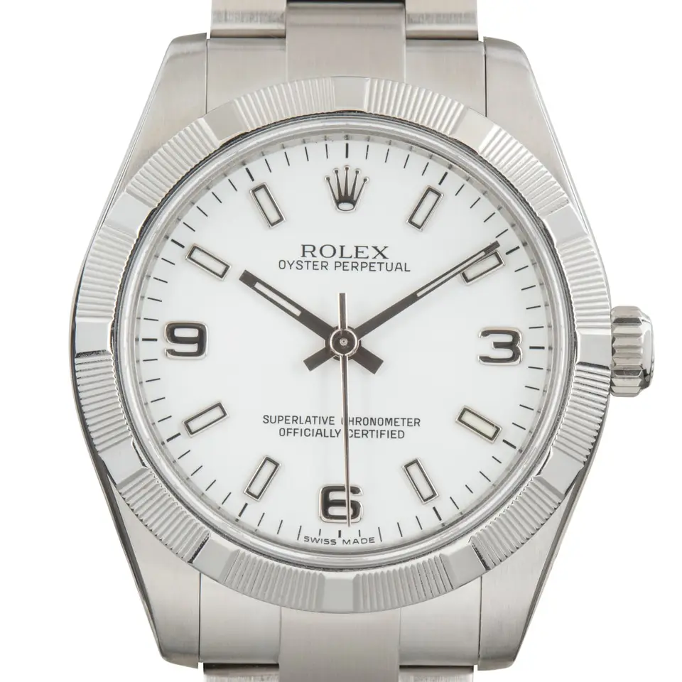 Rolex Oyster Perpetual 31 177210 with a white dial with 3, 6 and 9 numerals, engine-turned steel bezel and steel Oyster bracelet, a pre-owned example, studio close-up of the case