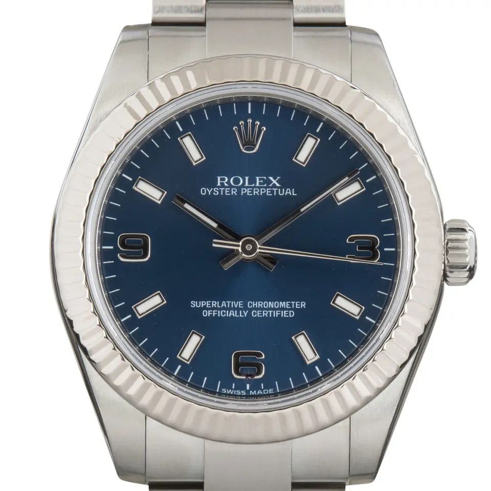 Rolex Oyster Perpetual 31 177234 with a blue dial and fluted white gold bezel on a steel Oyster bracelet, a pre-owned example, studio close-up of the case