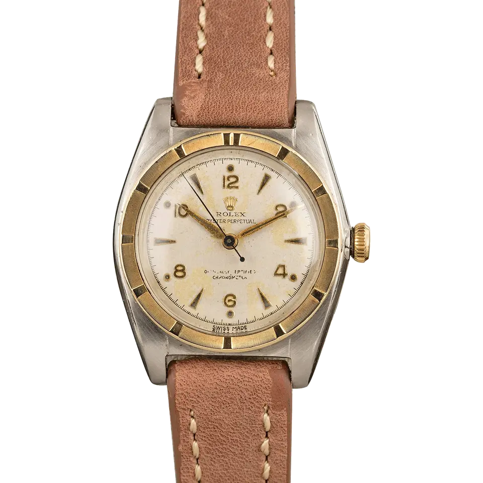 Rolex Oyster Perpetual 5015 with a cream Arabic-numeral dial, engine-turned gold bezel and steel and gold case on a brown leather strap, a pre-owned example, front view of the whole watch