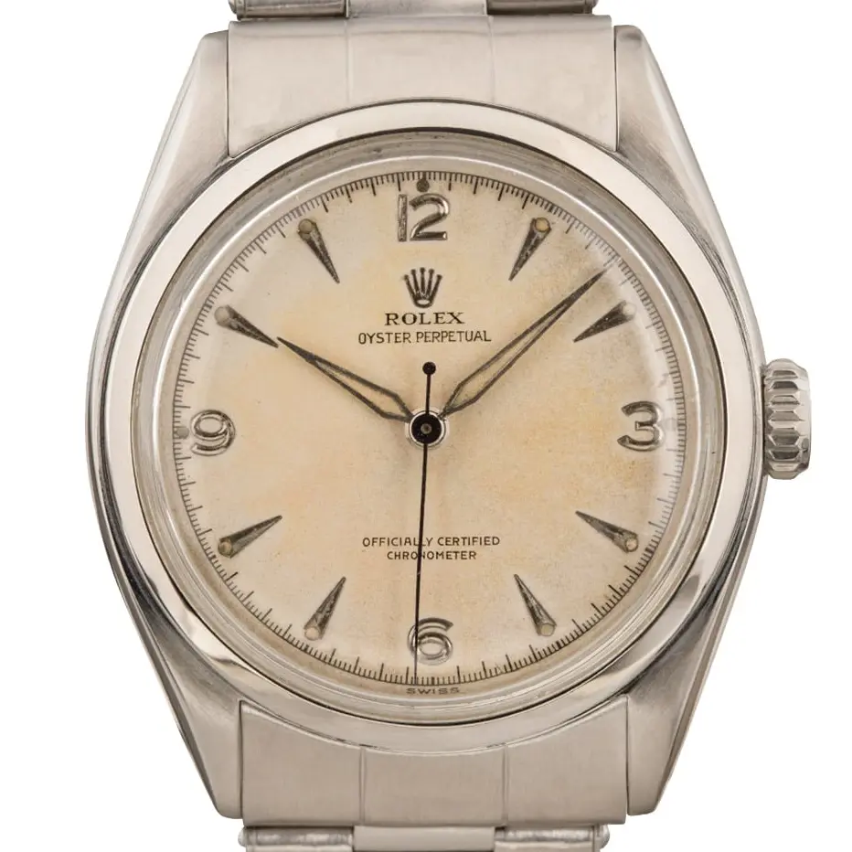 Rolex Oyster Perpetual 34 6084 with a cream dial with 3, 6, 9 and 12 numerals, smooth steel bezel and steel Oyster bracelet, a pre-owned example, studio close-up of the case