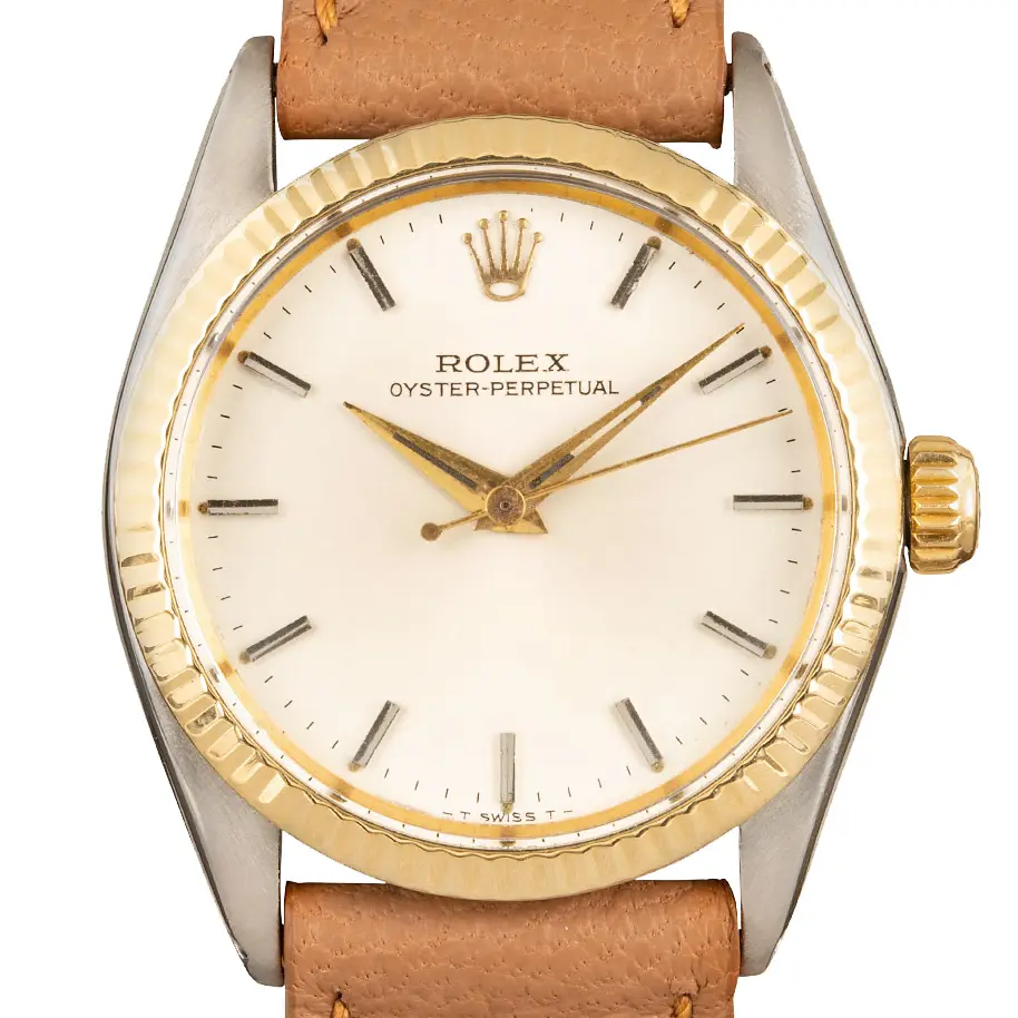 Rolex Oyster Perpetual 31 6551 with a silver dial, fluted yellow gold bezel and steel and gold case on a tan leather strap, a pre-owned example, studio close-up of the case
