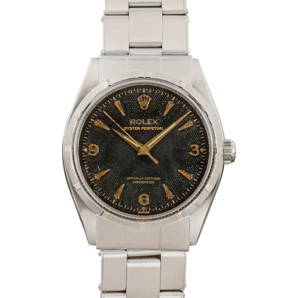 Rolex Oyster Perpetual 6565 with a black honeycomb dial with 3, 6 and 9 numerals, engine-turned steel bezel and steel Oyster bracelet, a pre-owned example, front view of the whole watch