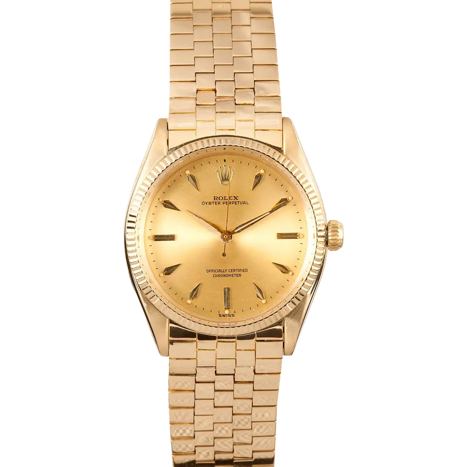 Rolex Oyster Perpetual 34 6567 with a champagne dial with arrow markers, engine-turned yellow gold bezel and yellow gold bracelet, a pre-owned example, front view of the whole watch